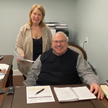 Bill Cervellero at his desk with Pat Cervellero in the Yardley office